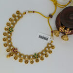 Antique Gold Kundan Necklace with Floral Motifs and Jhumka Earrings