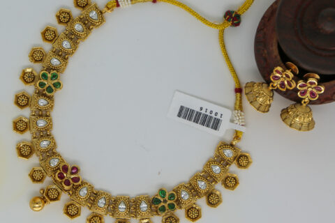 Antique Gold Kundan Necklace with Floral Motifs and Jhumka Earrings